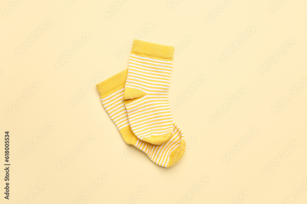 Pair of cotton socks on color background