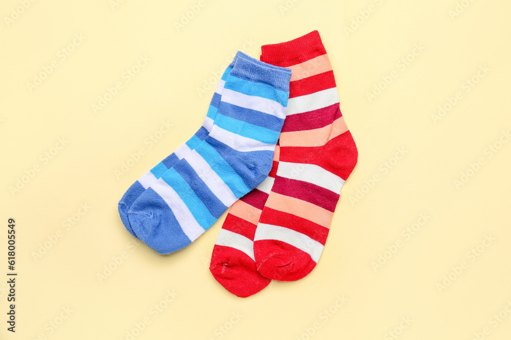 Striped cotton socks on color background