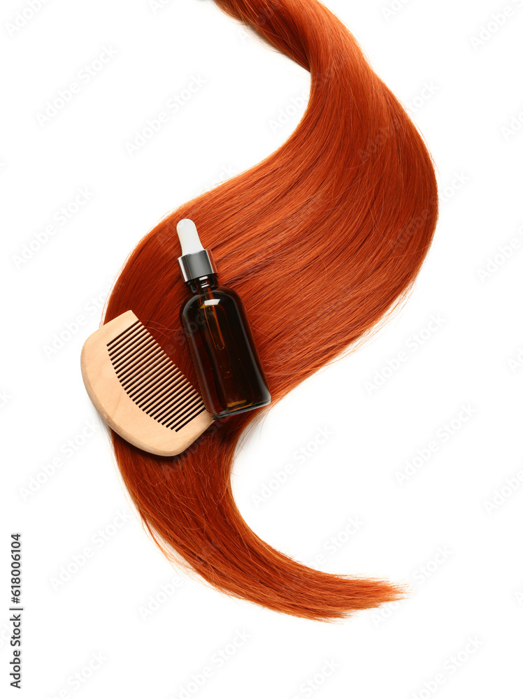 Ginger hair strand, comb and bottle of cosmetic product on white background, closeup