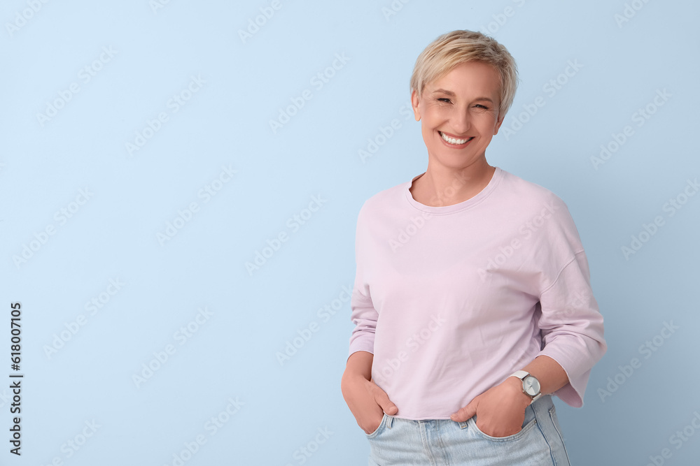 Mature blonde woman on blue background