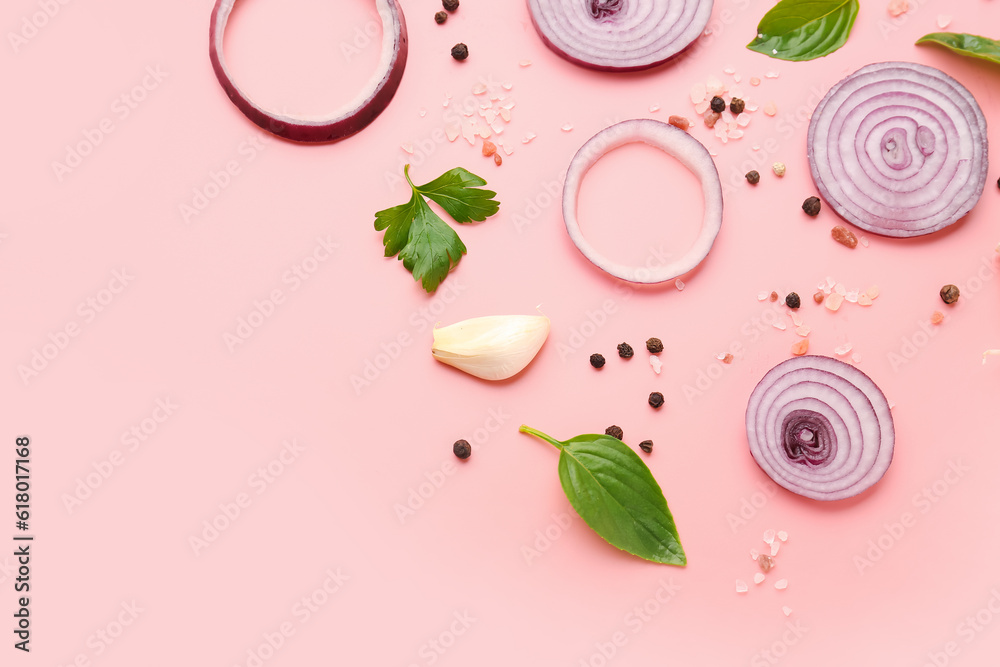 Fresh onion slices and spices on pink background