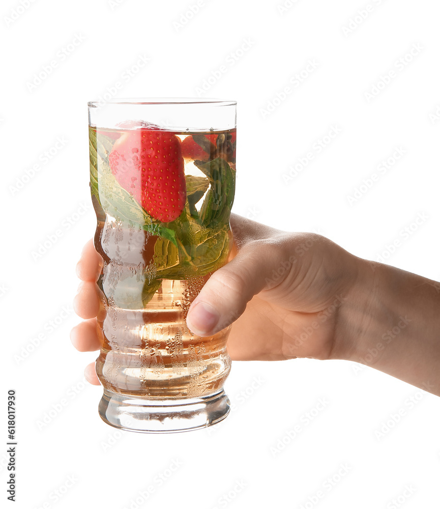 Female hand holding glass of ice tea with strawberry and mint on white background