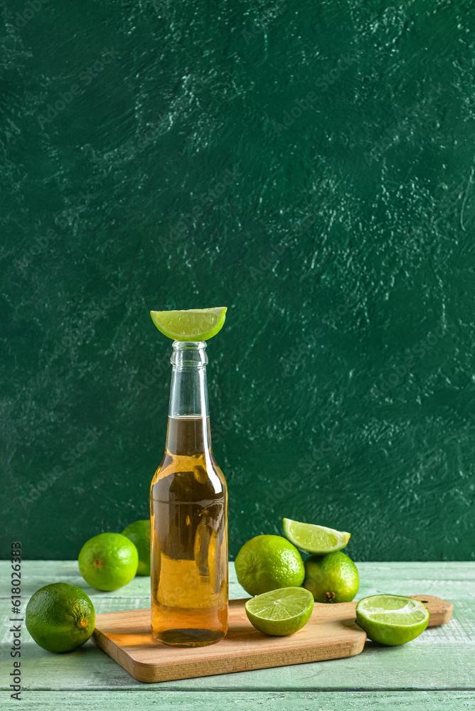 Bottle of cold beer with lime on table