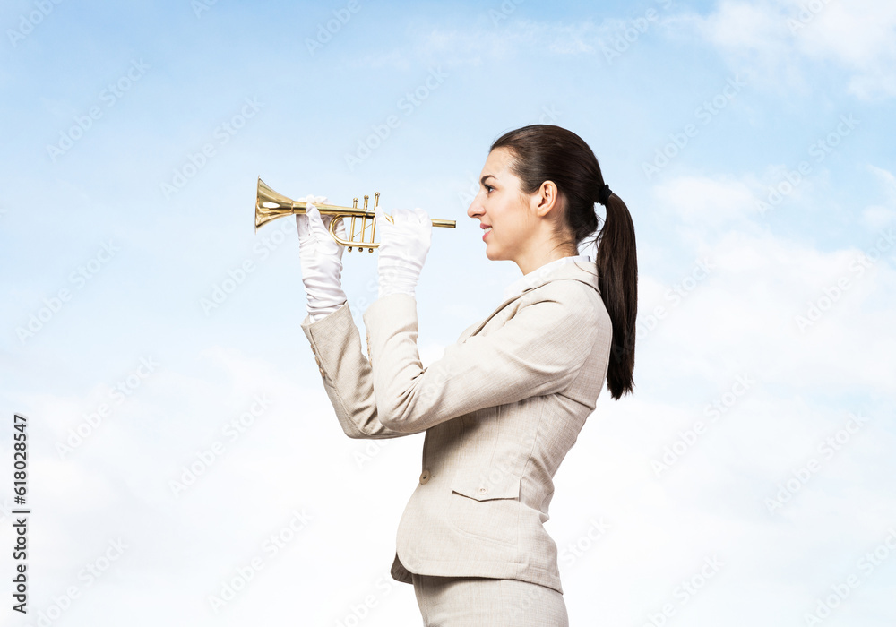 Beautiful woman playing trumpet brass