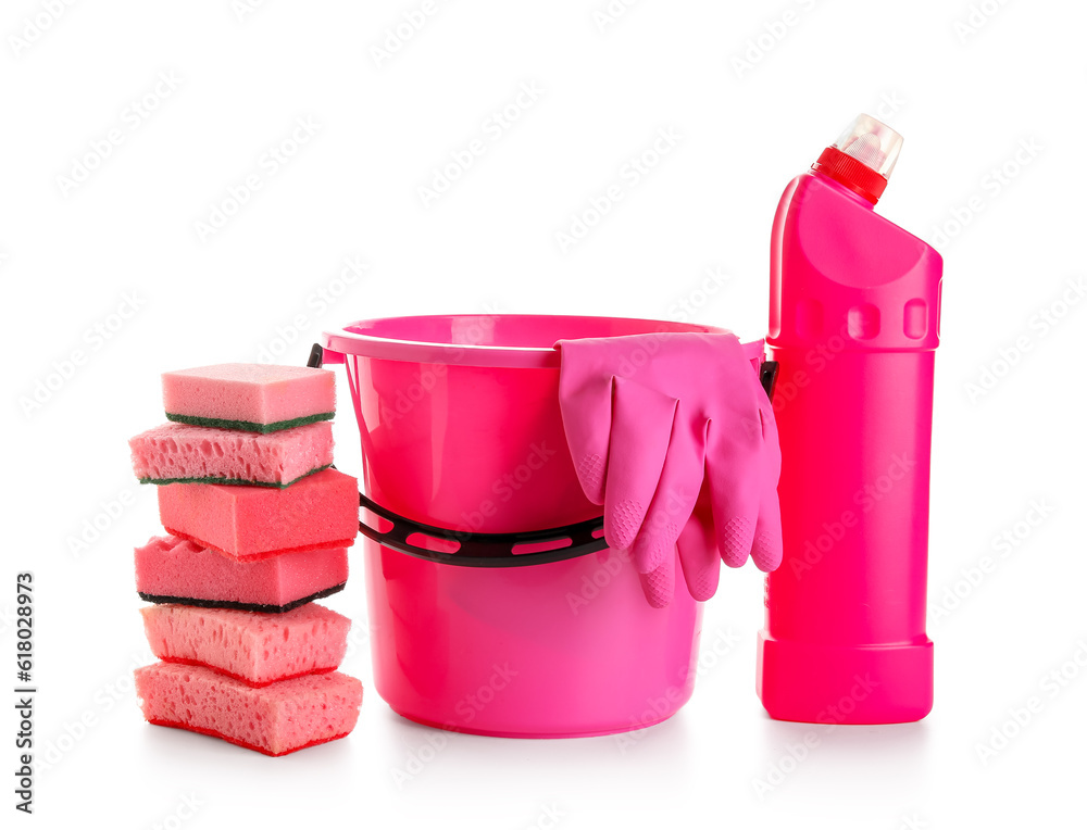 Bottle of detergent, plastic bucket with rubber gloves and stacked sponges isolated on white backgro