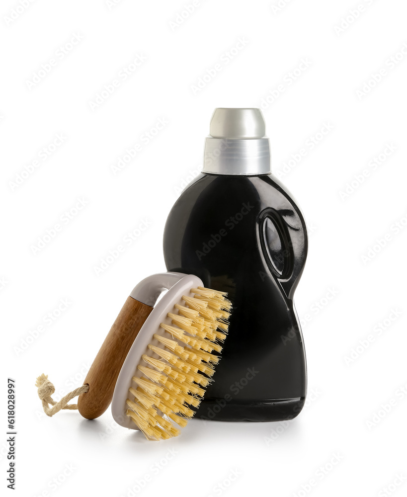 Bottle of detergent and brush isolated on white background