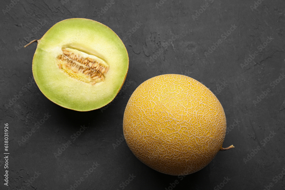 Sweet melon with half on black background