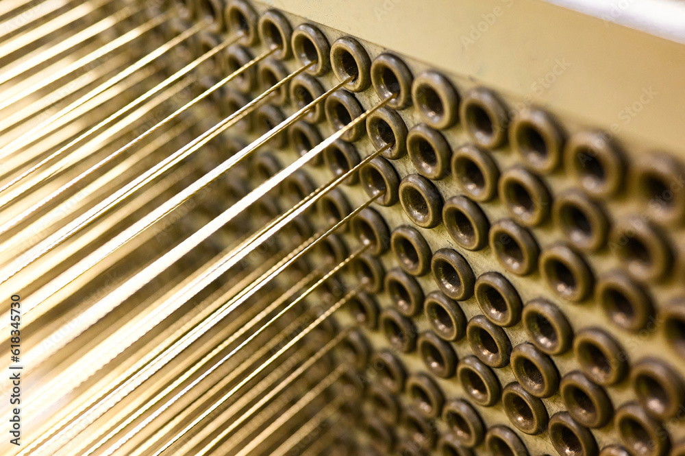 Strained cables pull out from holes of machine tool in shop