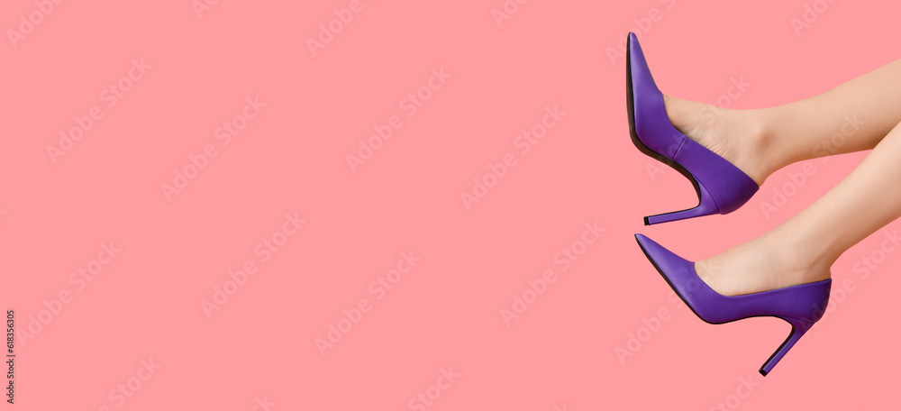 Female legs in stylish high heels on pink background with space for text