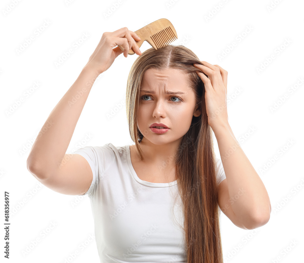 Worried young woman with hair loss problem on white  background