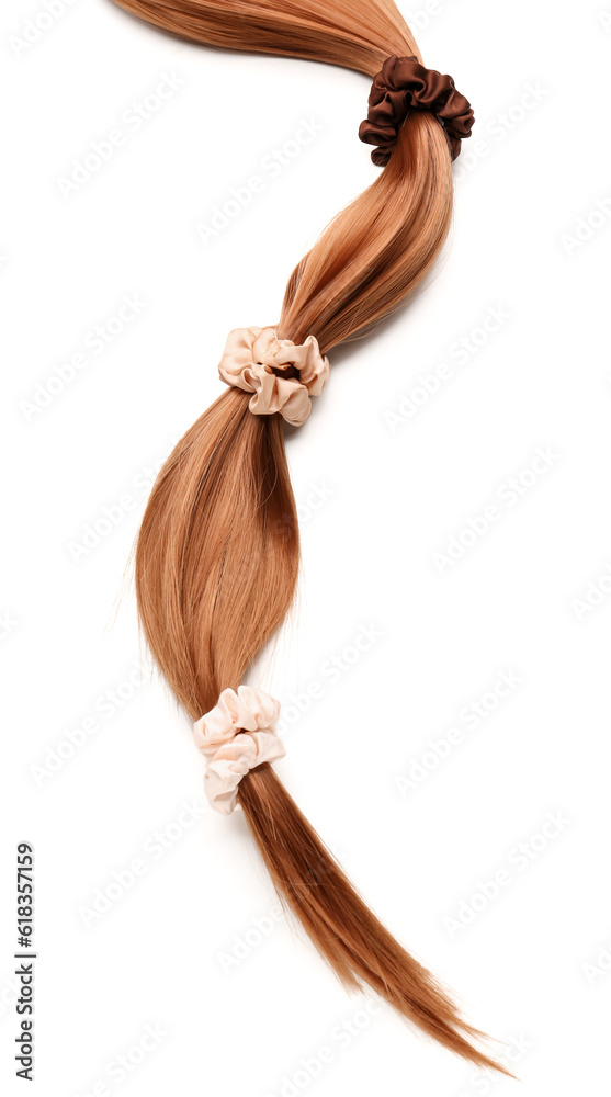 Hair strand with scrunchies on white background, closeup