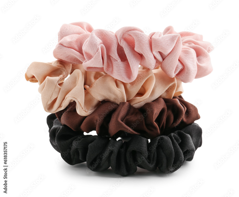 Set of stylish silk scrunchies on white background