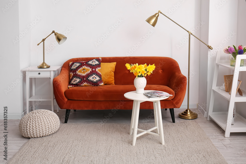 Interior of stylish living room with cozy sofa, coffee table and lamps