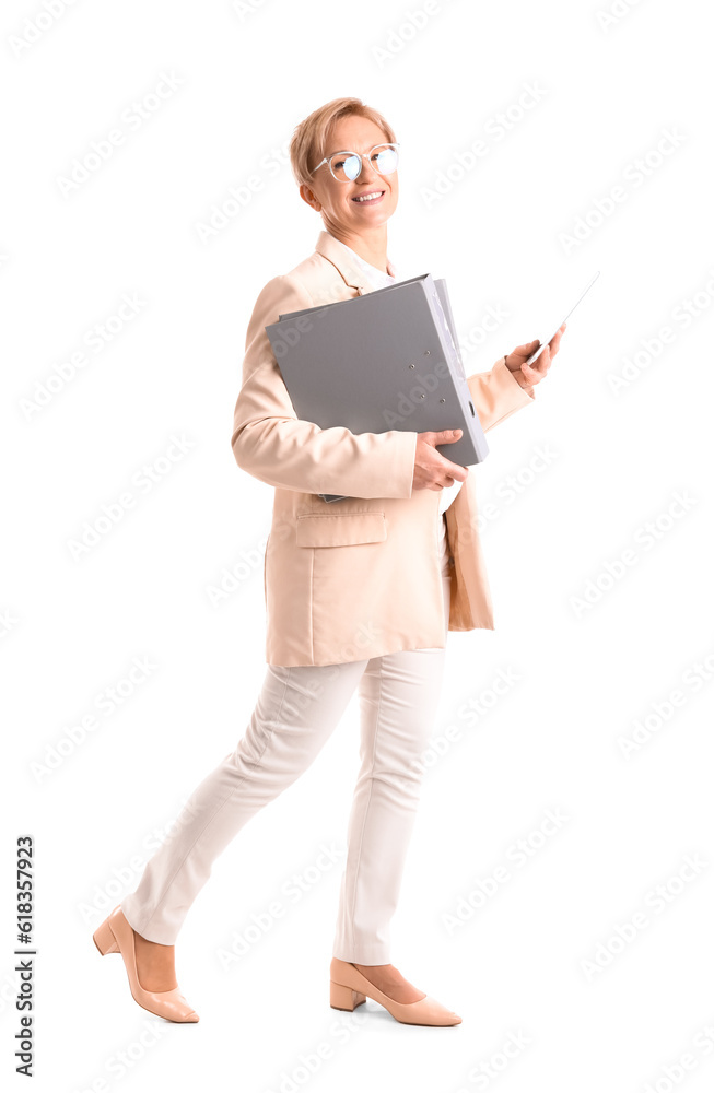 Mature businesswoman with folders and tablet computer on white background