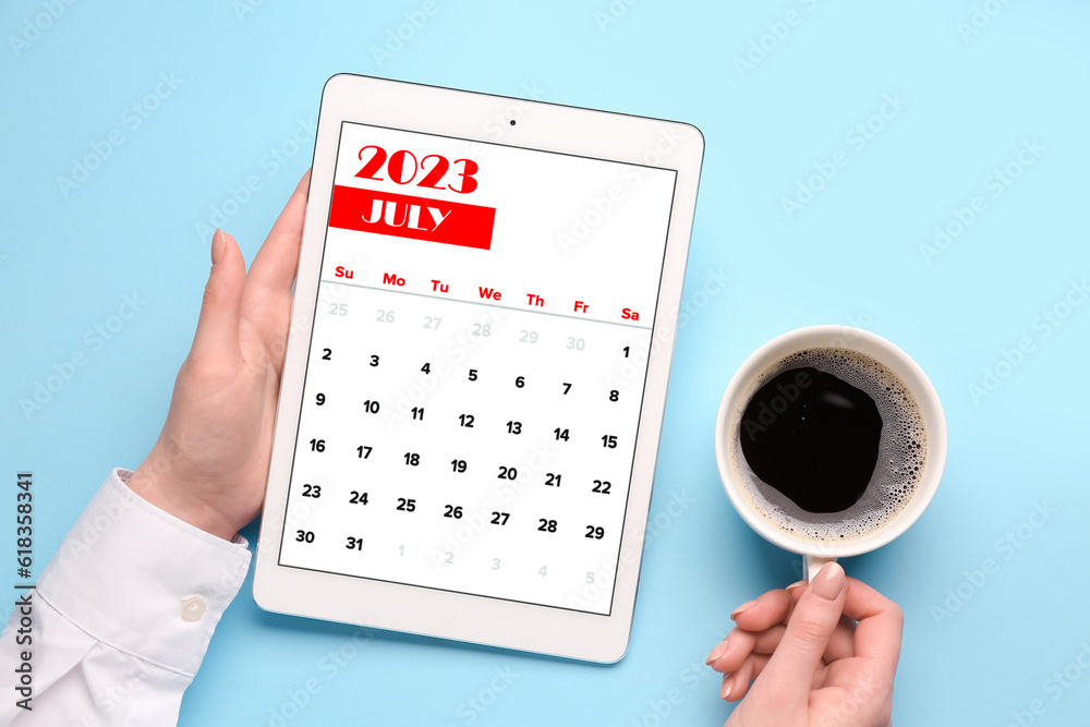 Woman holding tablet computer with calendar and cup of coffee on blue background