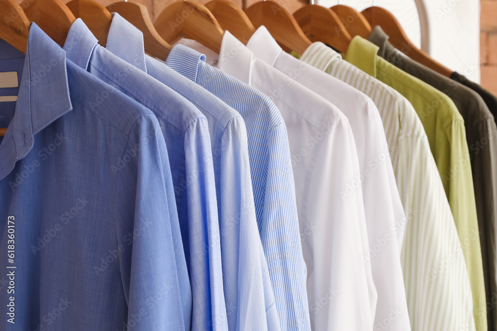 Rack with stylish shirts in boutique, closeup