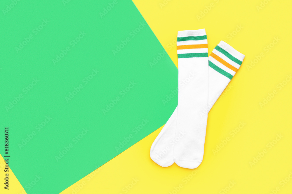 Pair of soft cotton socks on color background