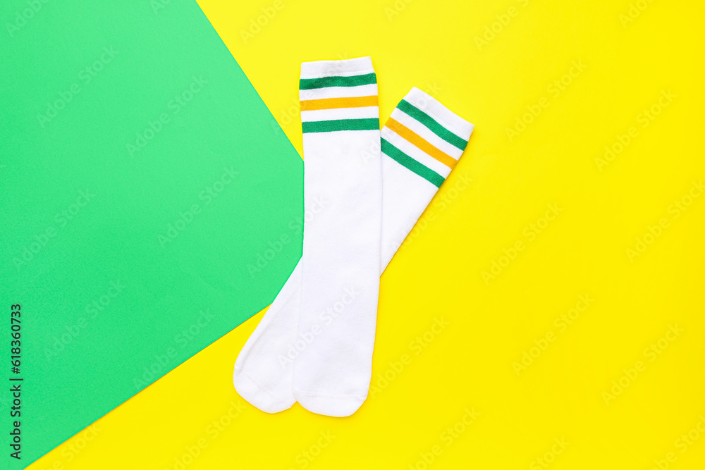 Pair of soft cotton socks on color background