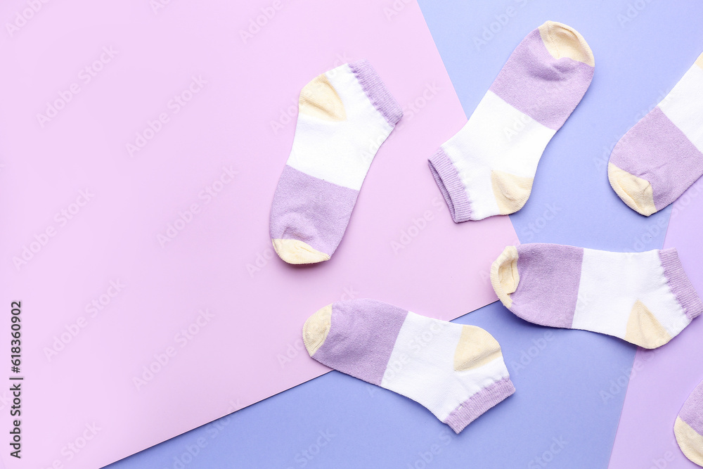 Many cotton socks on color background