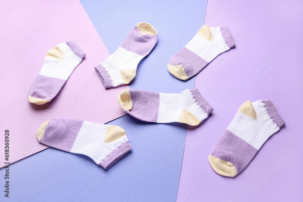 Many cotton socks on color background