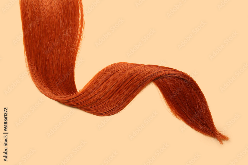 Ginger hair strand on color background, closeup