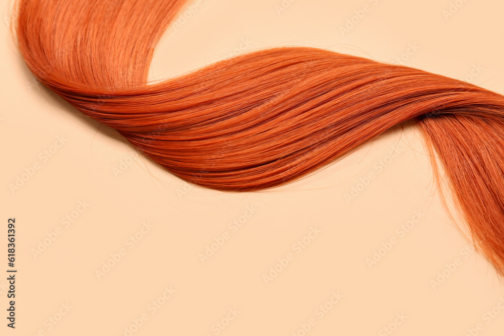 Ginger hair strand on color background, closeup