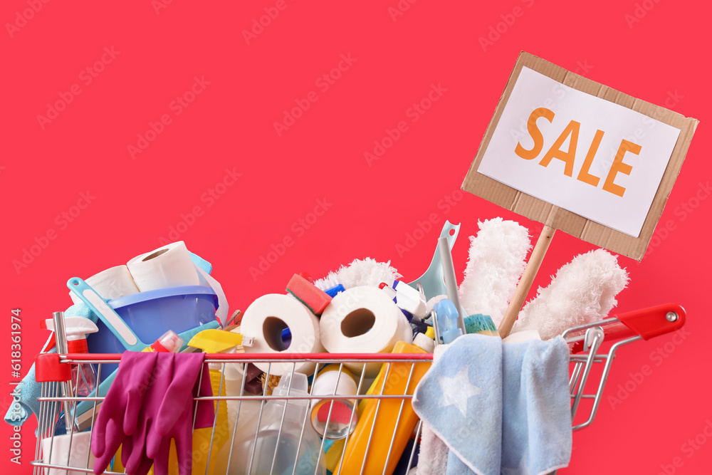 Shopping cart full of cleaning supplies with word SALE on red background