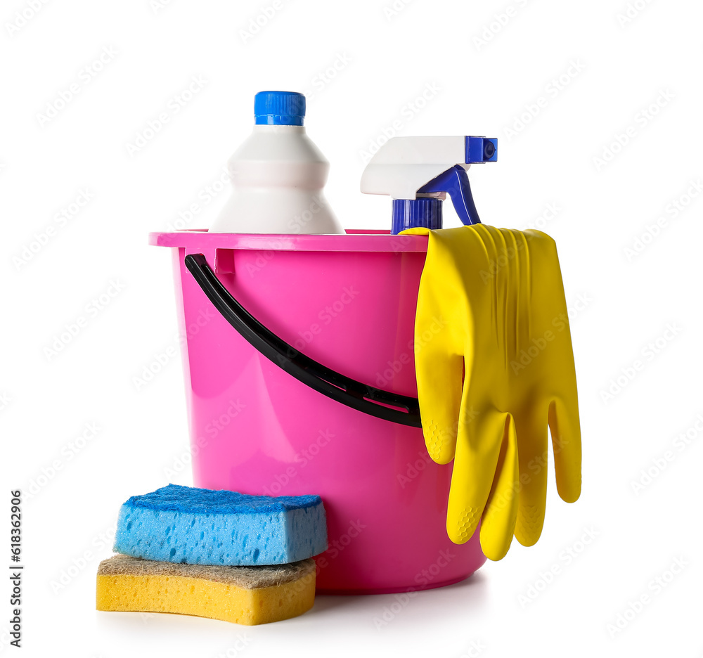 Bucket with different cleaning supplies on white background