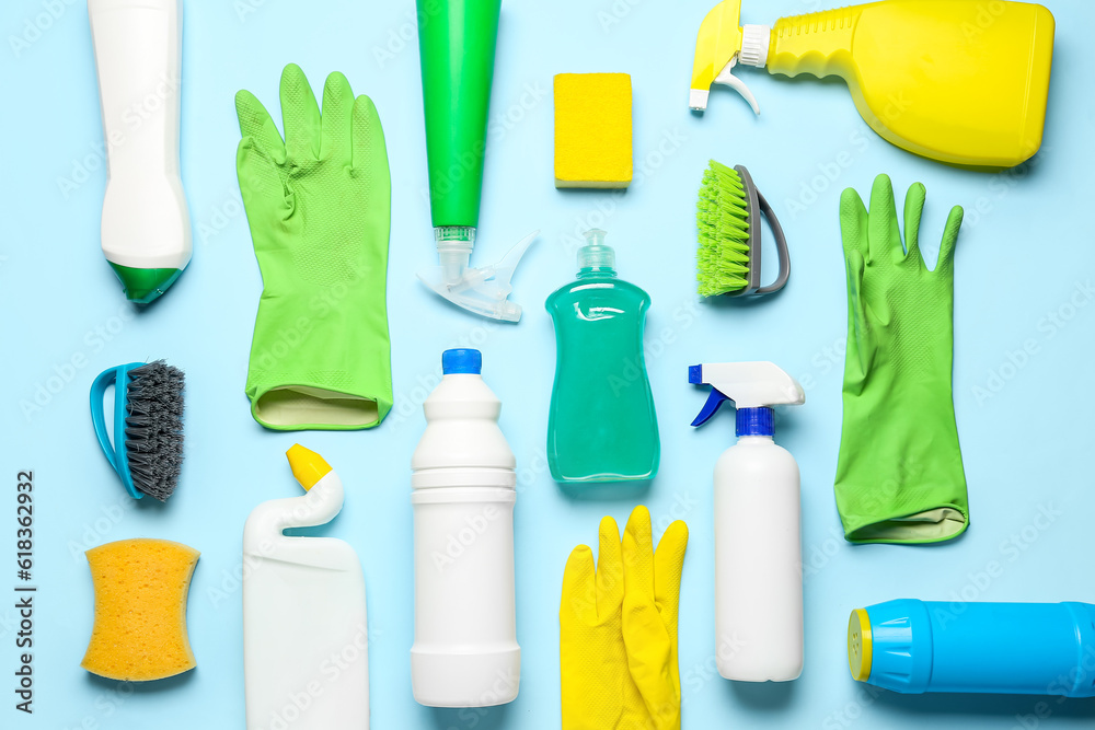 Different cleaning supplies on blue background