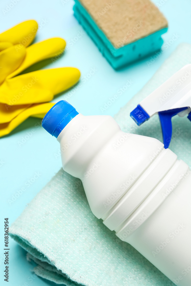 Different cleaning supplies on blue background, closeup