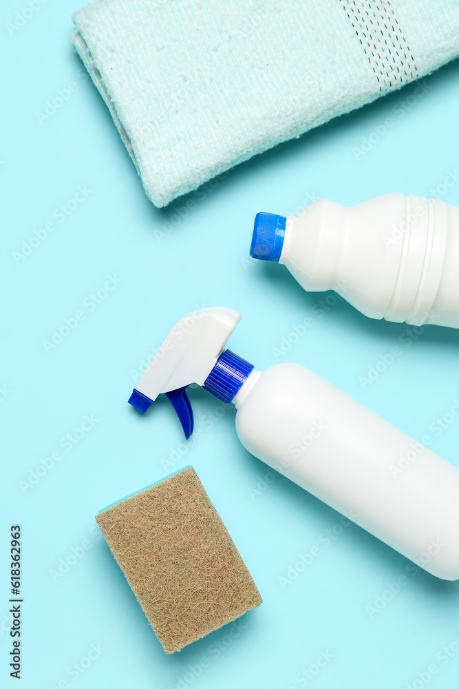 Different cleaning supplies on blue background