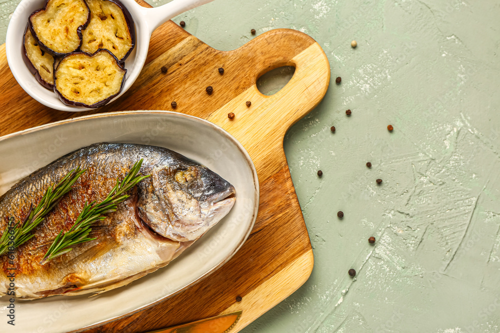 Plate with tasty grilled dorado fish on grey background