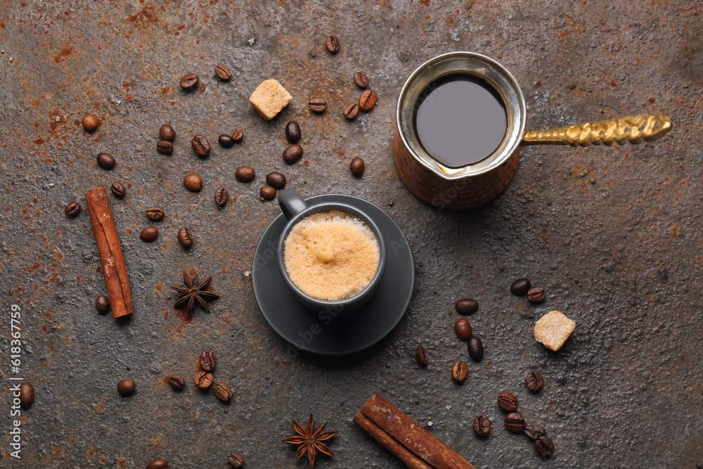 Cup and jezve of hot espresso on dark background