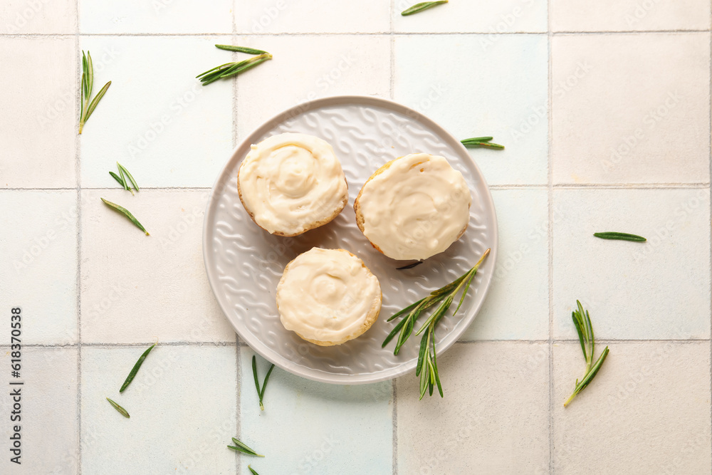 Plate of tasty croutons with cream cheese on white tile background