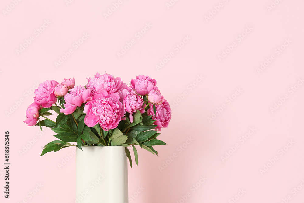 Vase of pink peonies on color background