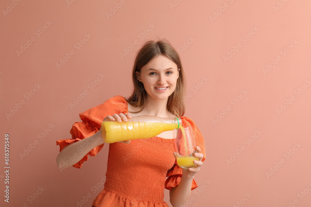 Teenage girl pouring orange juice into glass on pink background