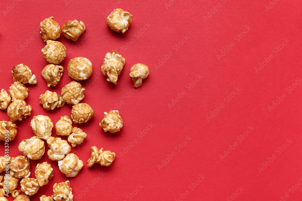 Tasty popcorn on red background