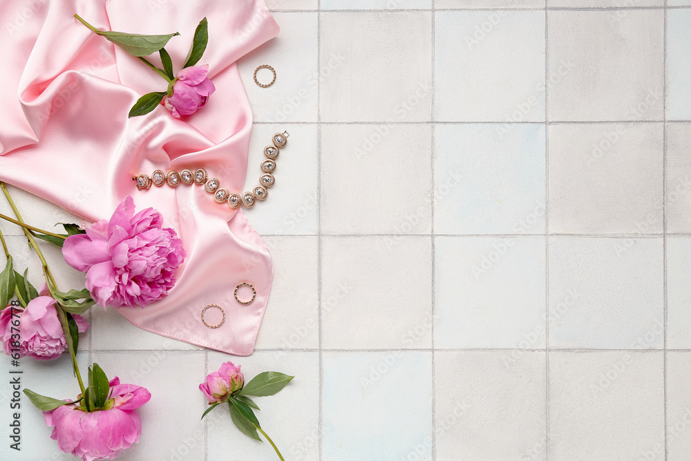 Composition with stylish female accessories and beautiful peony flowers on light tile background