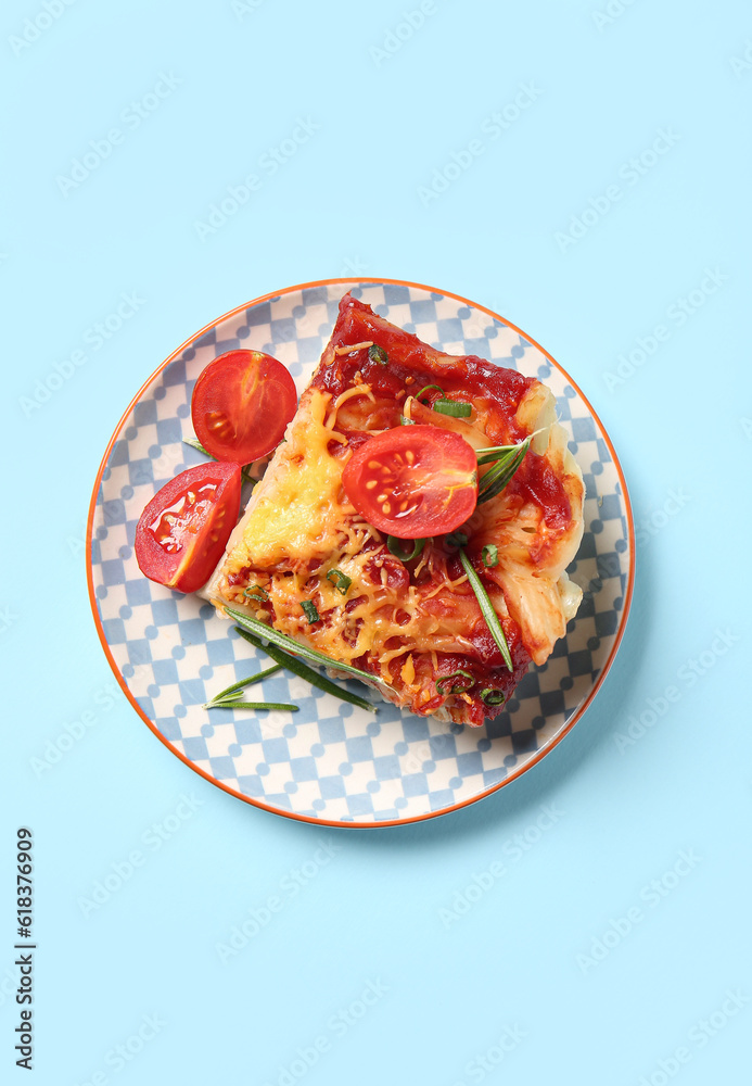 Plate of pasta with tomato sauce and cheese on blue background