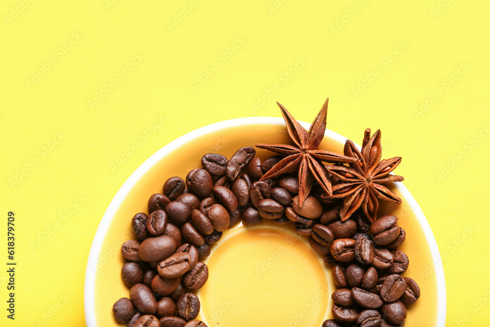 Frame made of coffee beans and star anise on yellow background