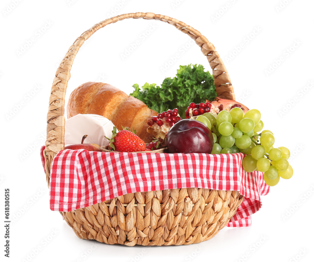 Wicker basket with delicious food for picnic on white background