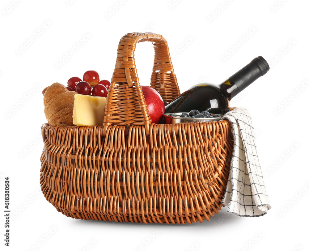 Wicker basket with tasty food for picnic and wine on white background