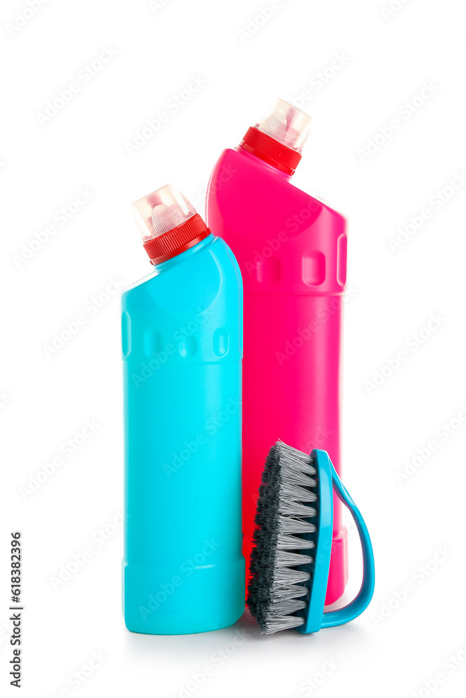 Bottles of detergent and brush isolated on white background