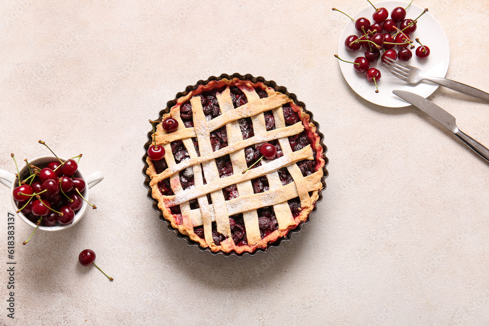 Baking dish with tasty cherry pie and plate of berries on white background