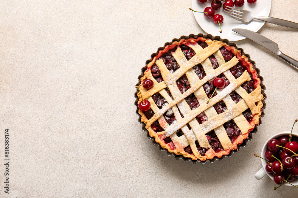 Baking dish with tasty cherry pie and plate of berries on white background