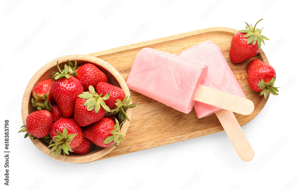 Wooden board with sweet strawberry ice-cream popsicles and bowl of berries on white background