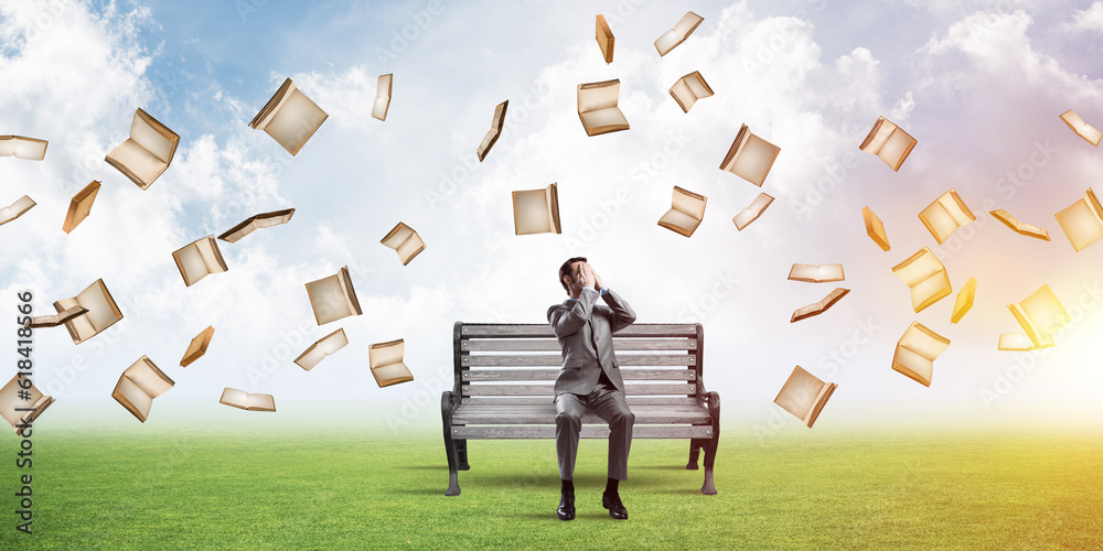 Young man in summer park on bench do not want to see anything