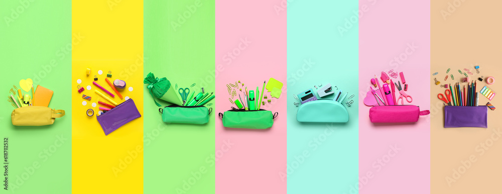 Collection of pencil cases with school stationery on color background