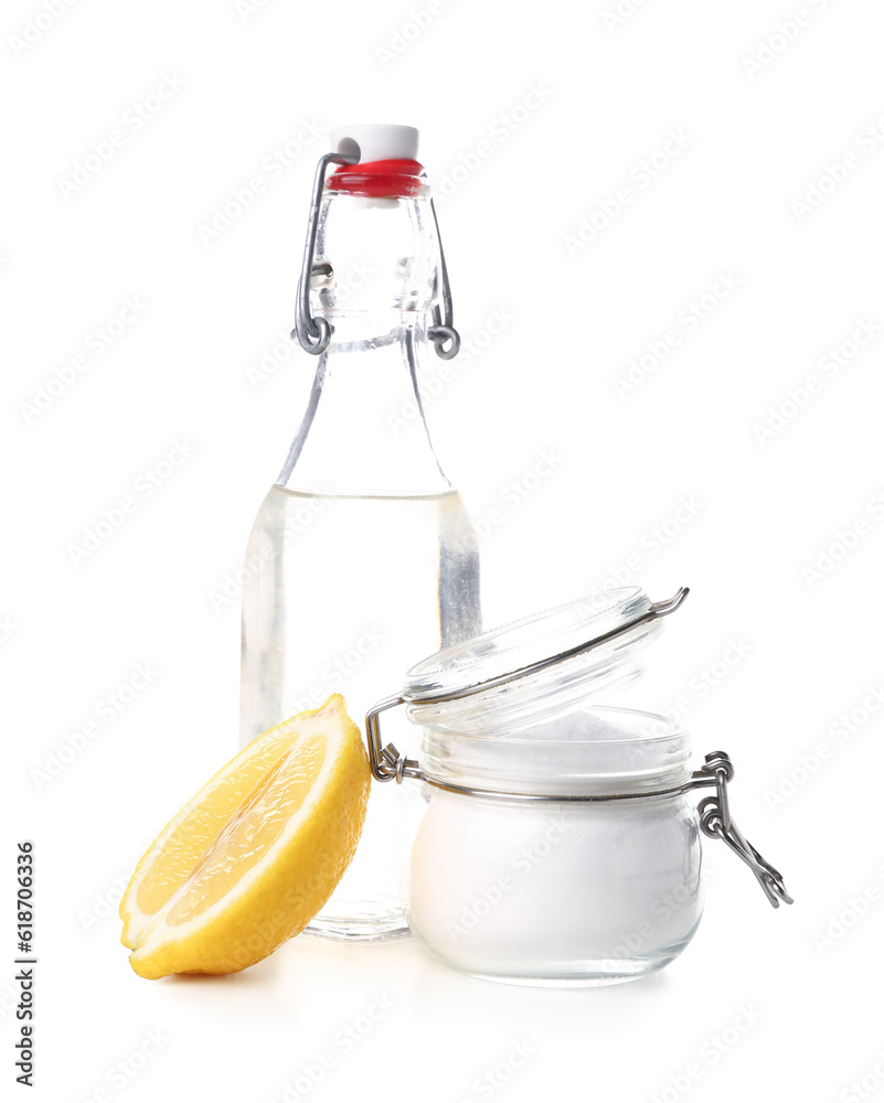 Jar with baking soda and bottle of vinegar for cleaning on white background