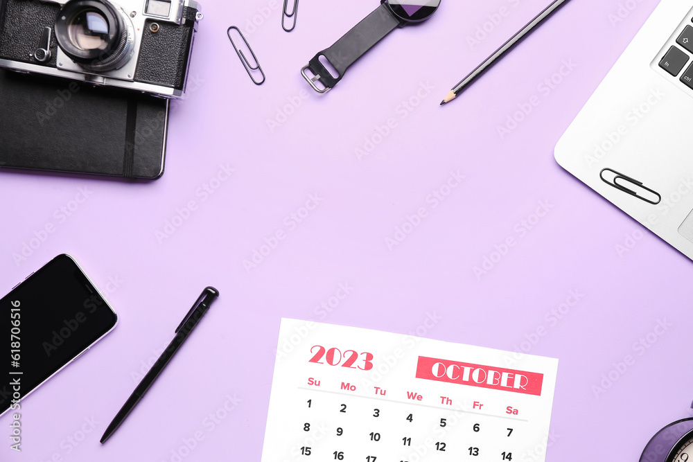 Composition with calendar, modern laptop, alarm clock, photo camera and mobile phone on lilac backgr